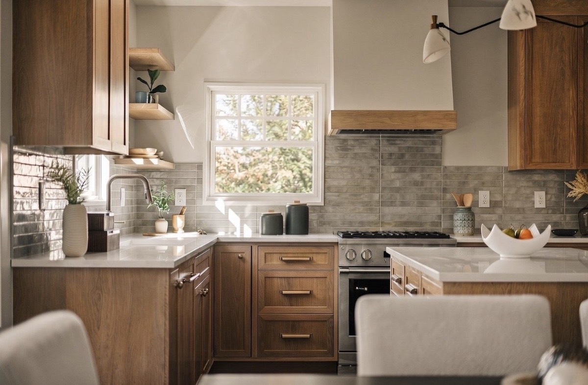White oak kitchen with gray handmade tile, open shelving and a window over the sink